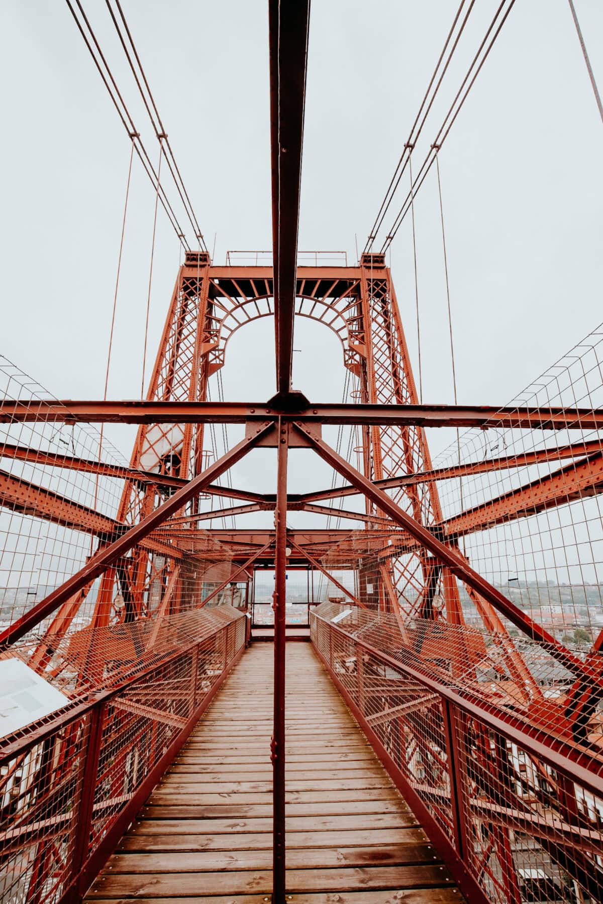 Red bridge tower with wooden walkway.