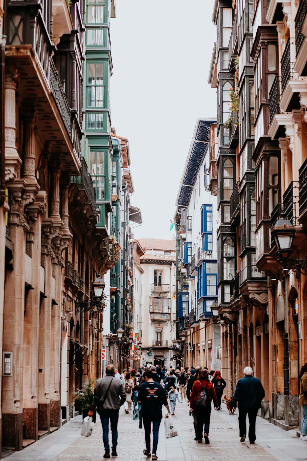 Lively old town street with colorful facades and passers-by.