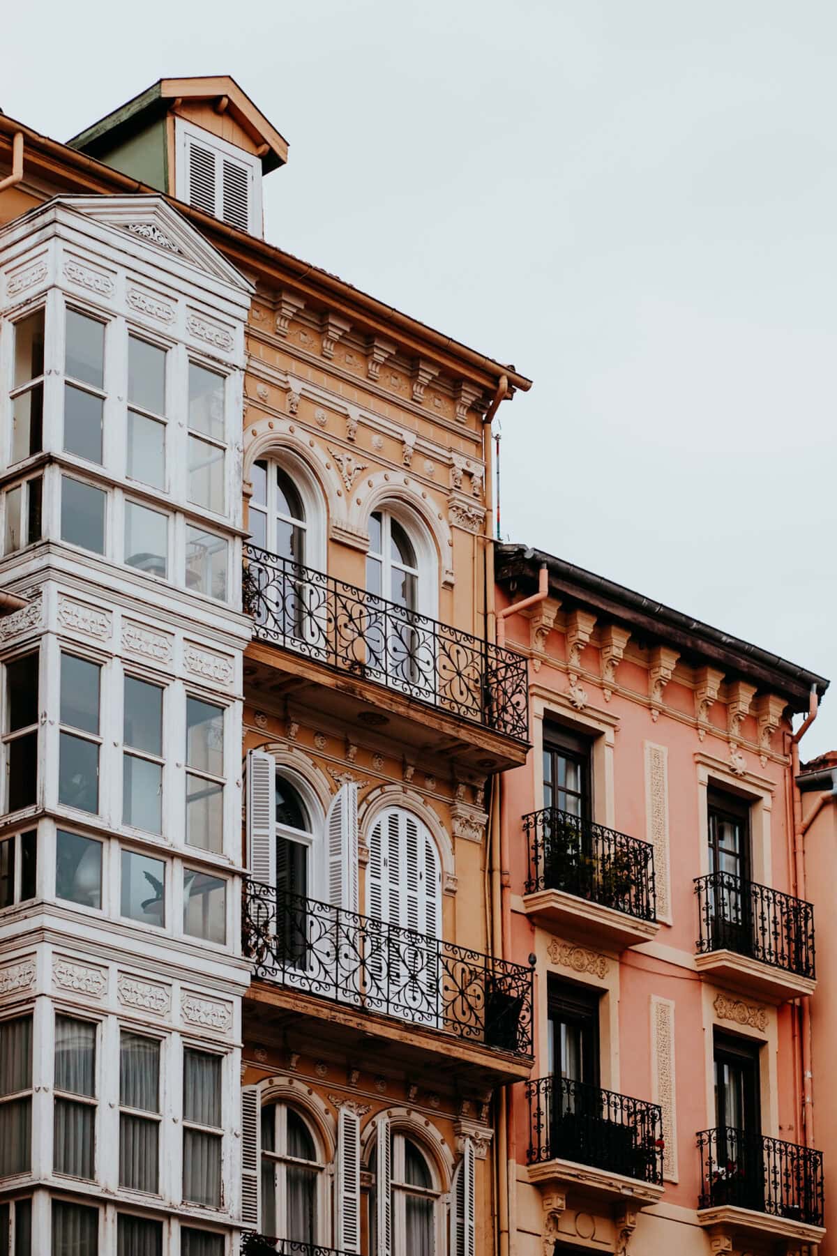 Historic buildings with wrought-iron balconies.
