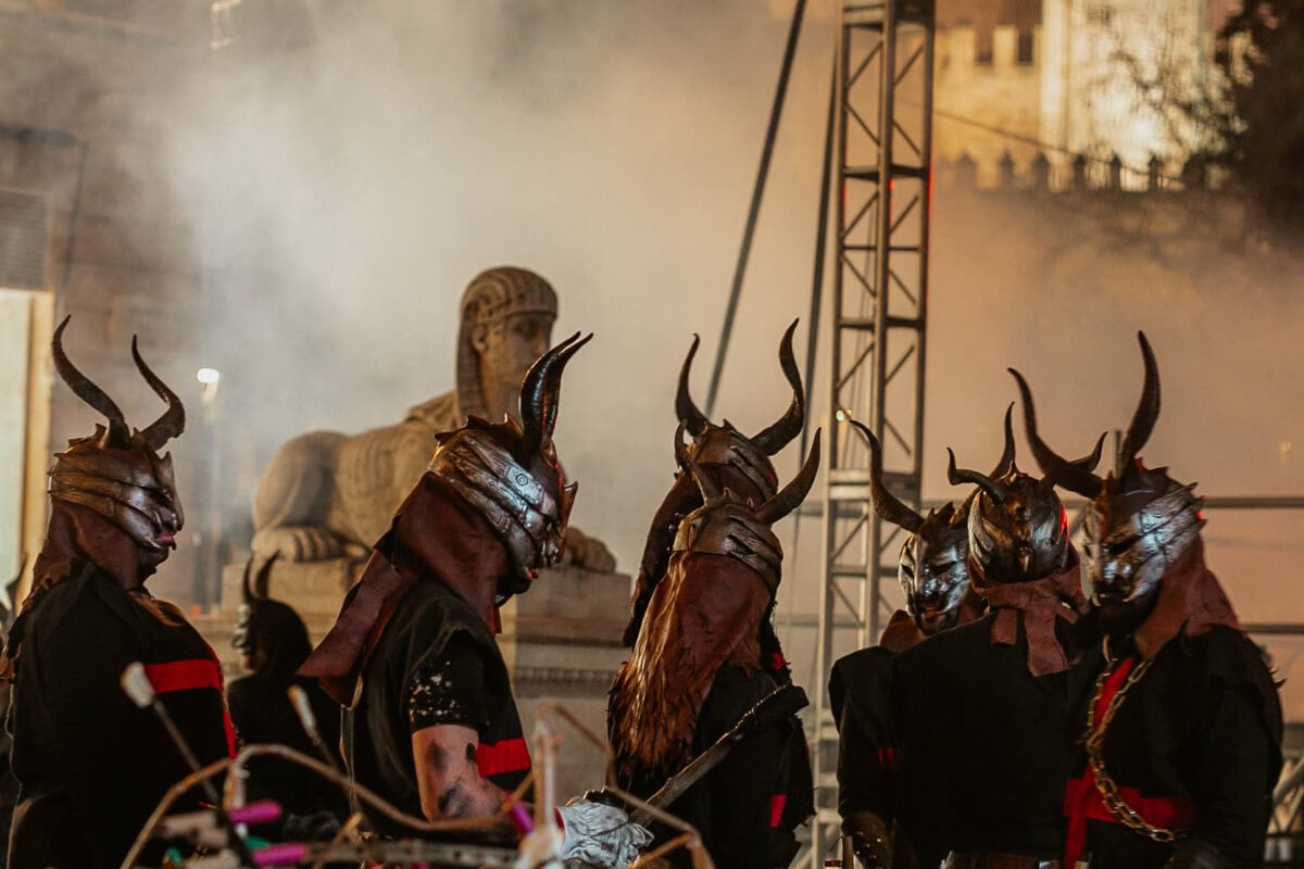 People in horned helmets at night event