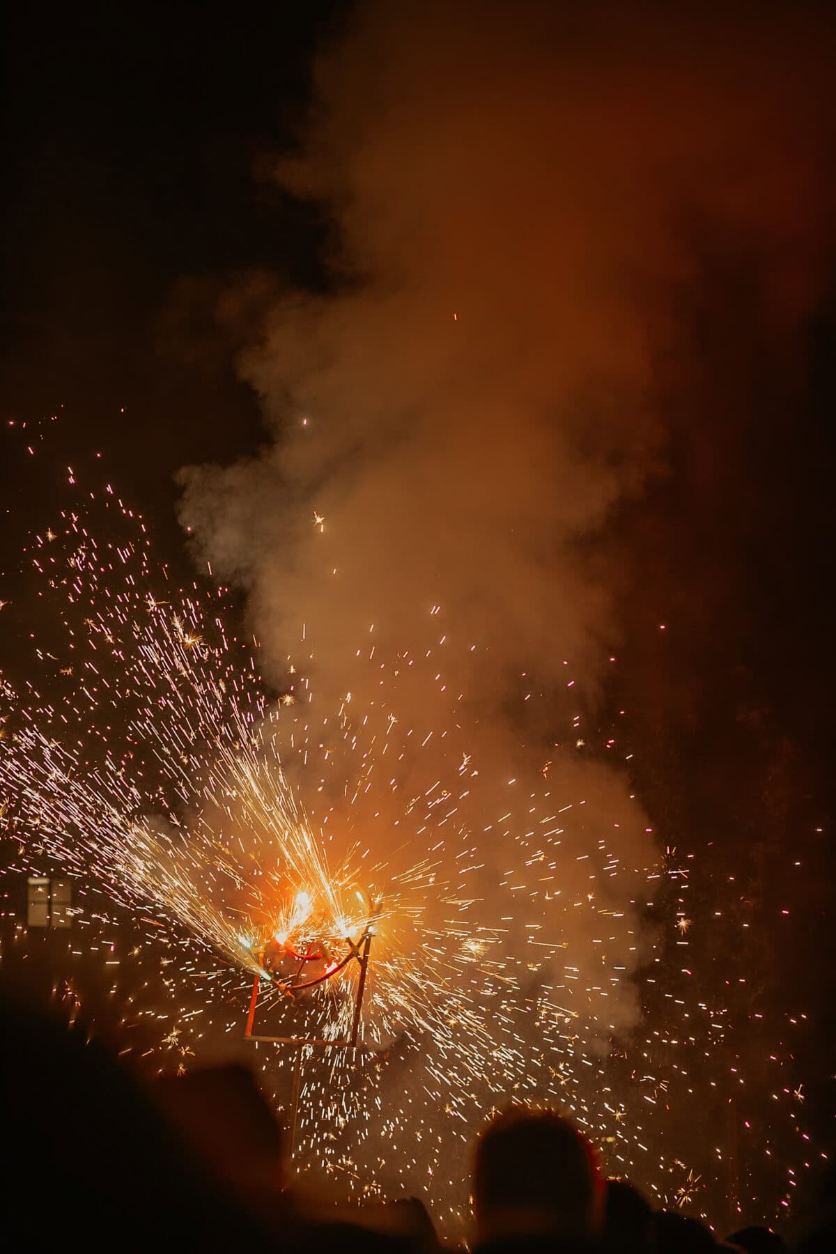 Fireworks at night with sparks and smoke.