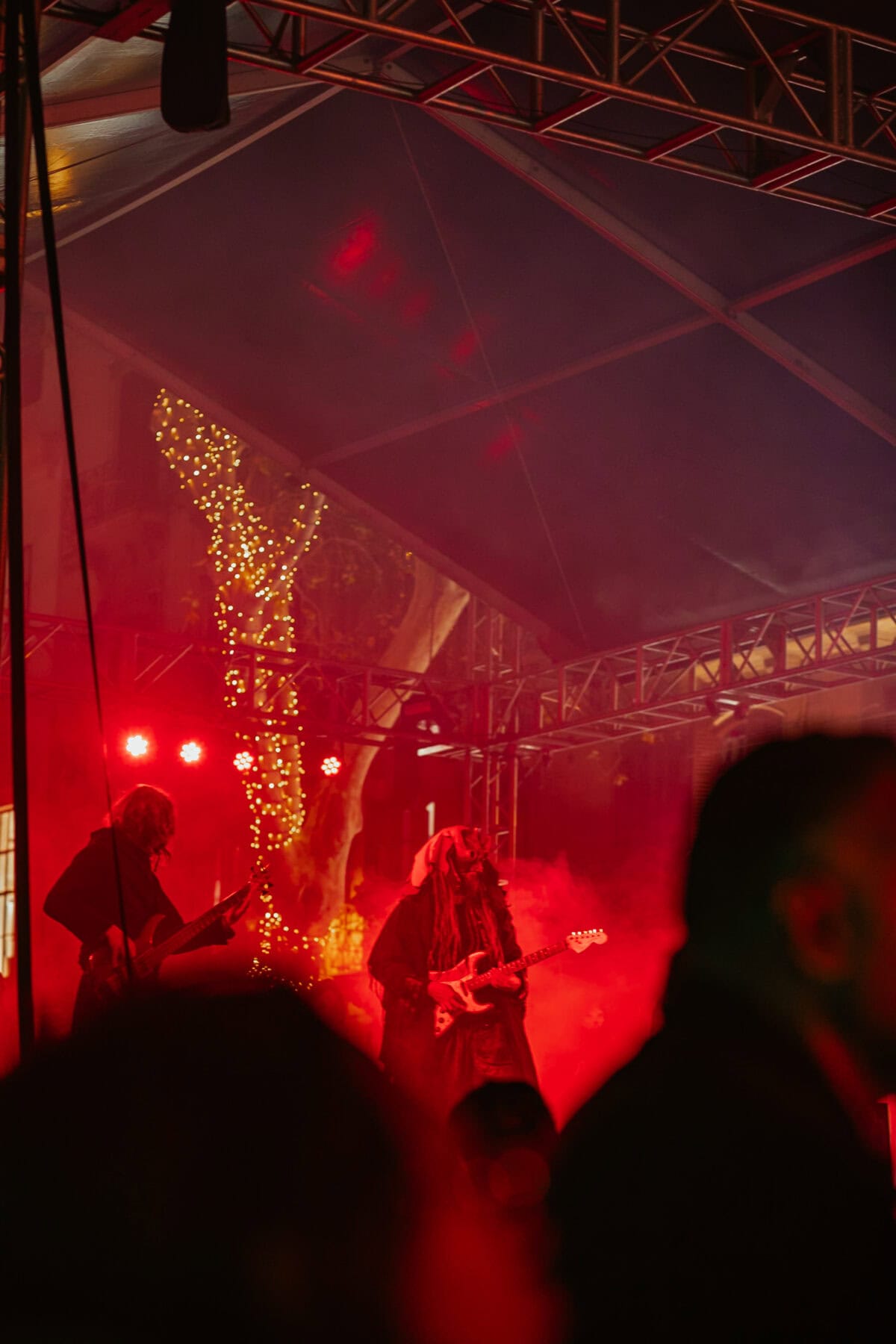 Musicians on a red stage with guitars