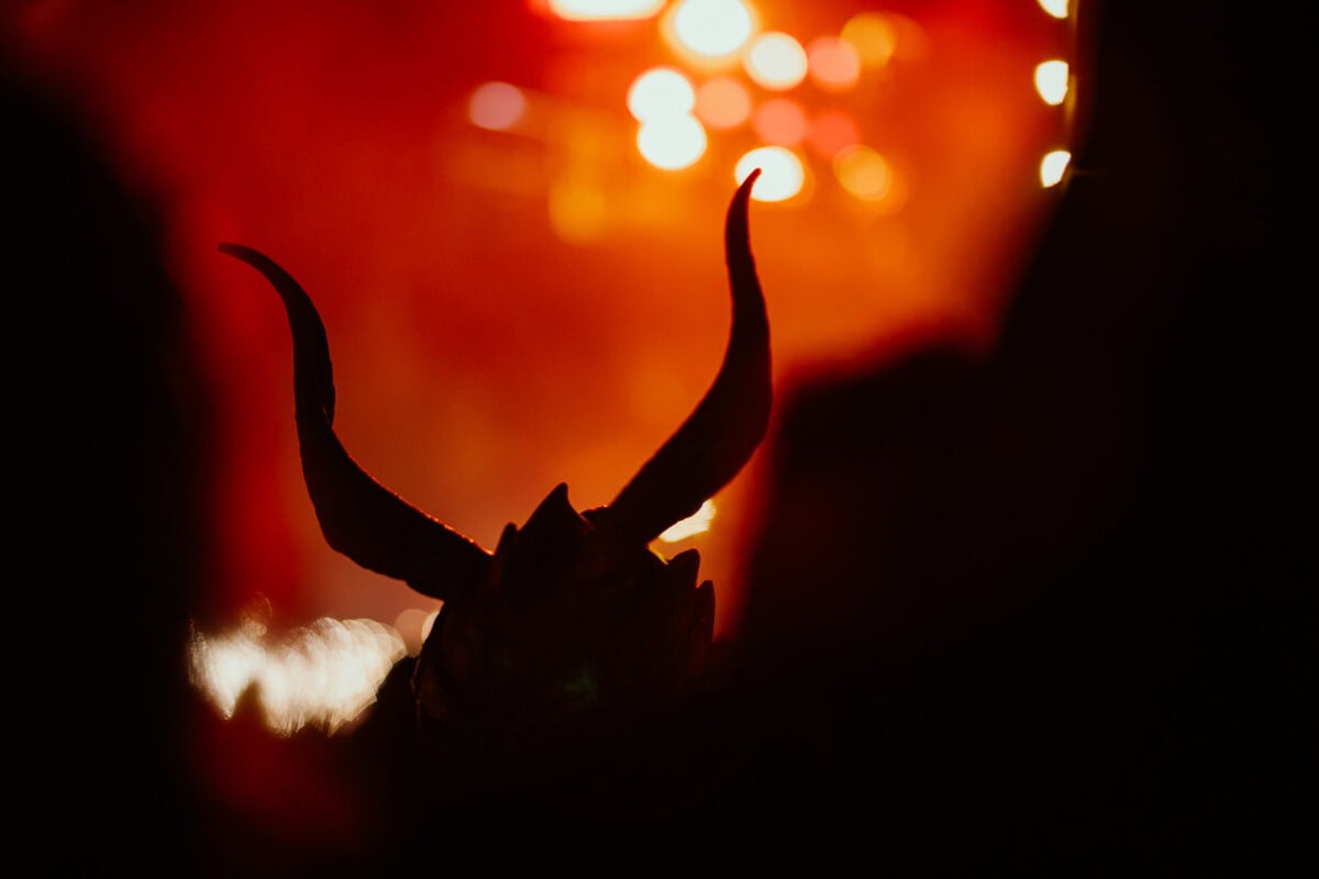 Demon shadows against an orange sky