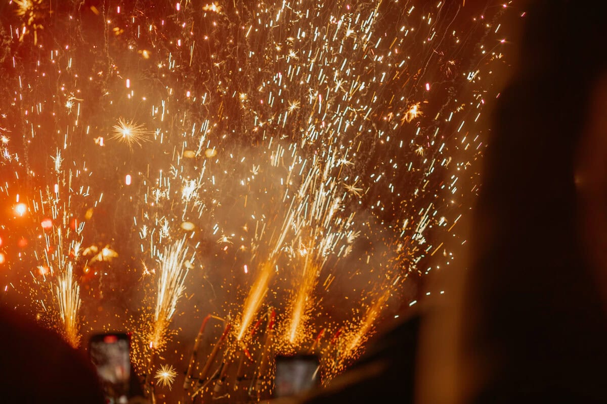 Fireworks light up the night sky with colorful sparks.