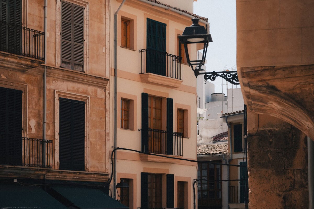 Historic buildings with balconies and shutters.