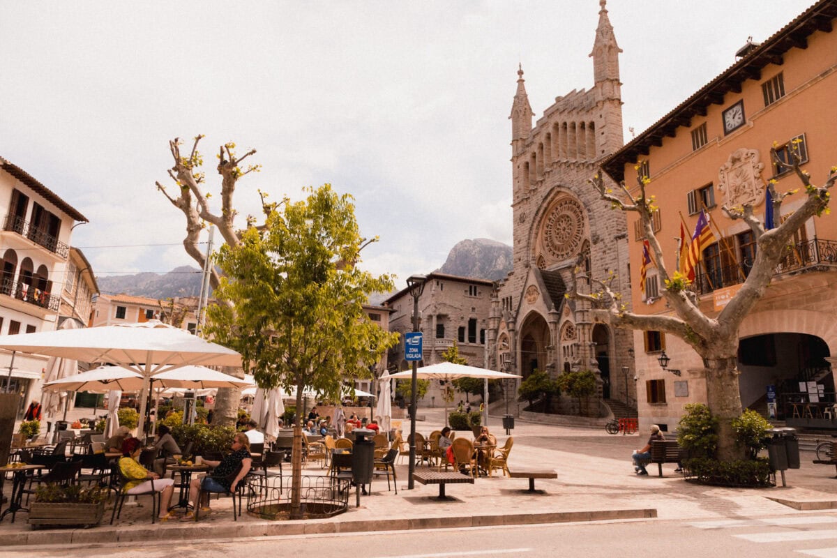 Town square with church and outdoor café terrace.