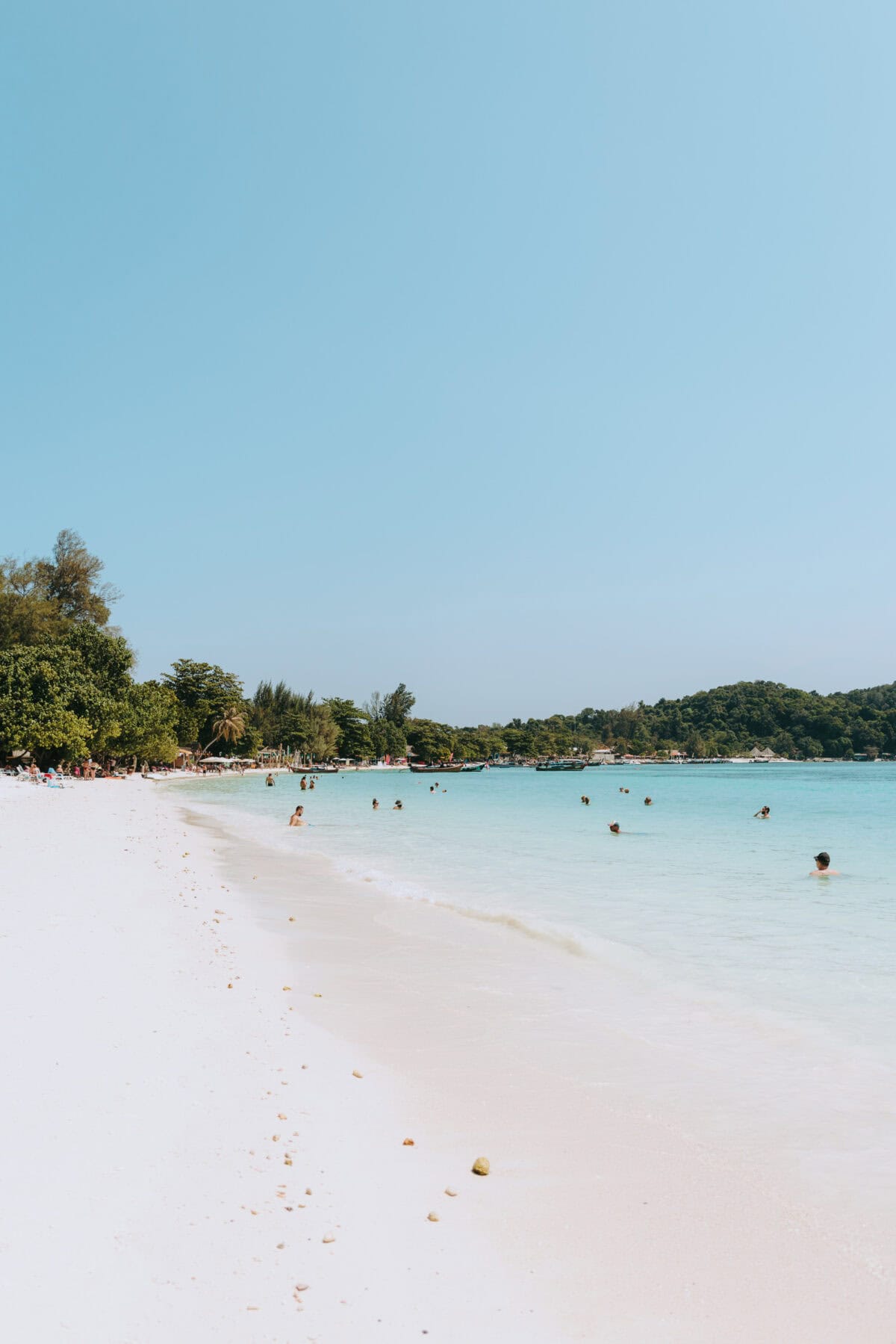 Tropical beach with turquoise blue sea and bathers