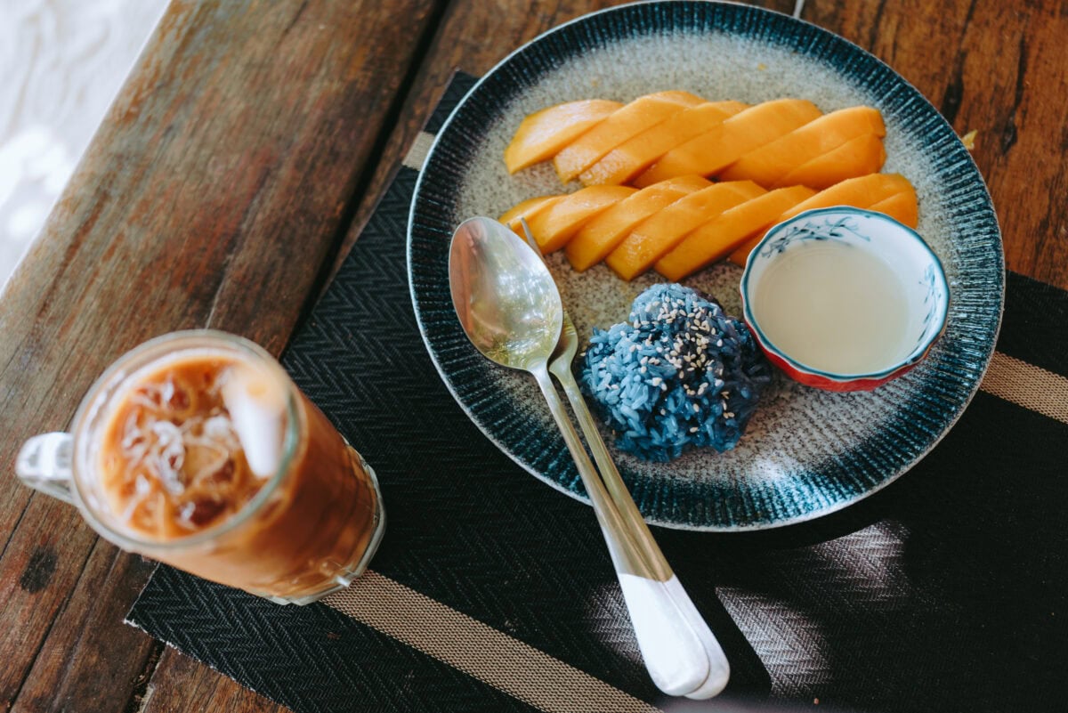 Mango with blue sticky rice and coconut sauce