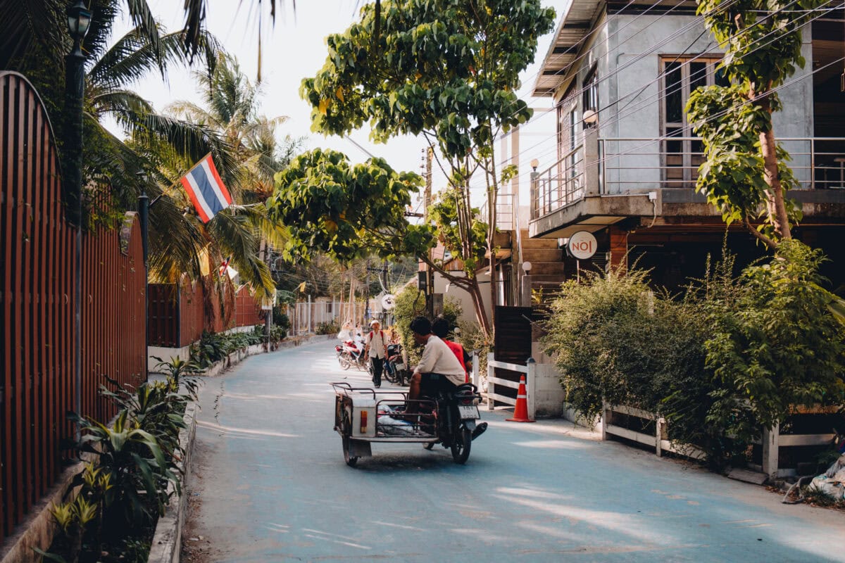 Narrow tropical road with motorcycle and sidecar
