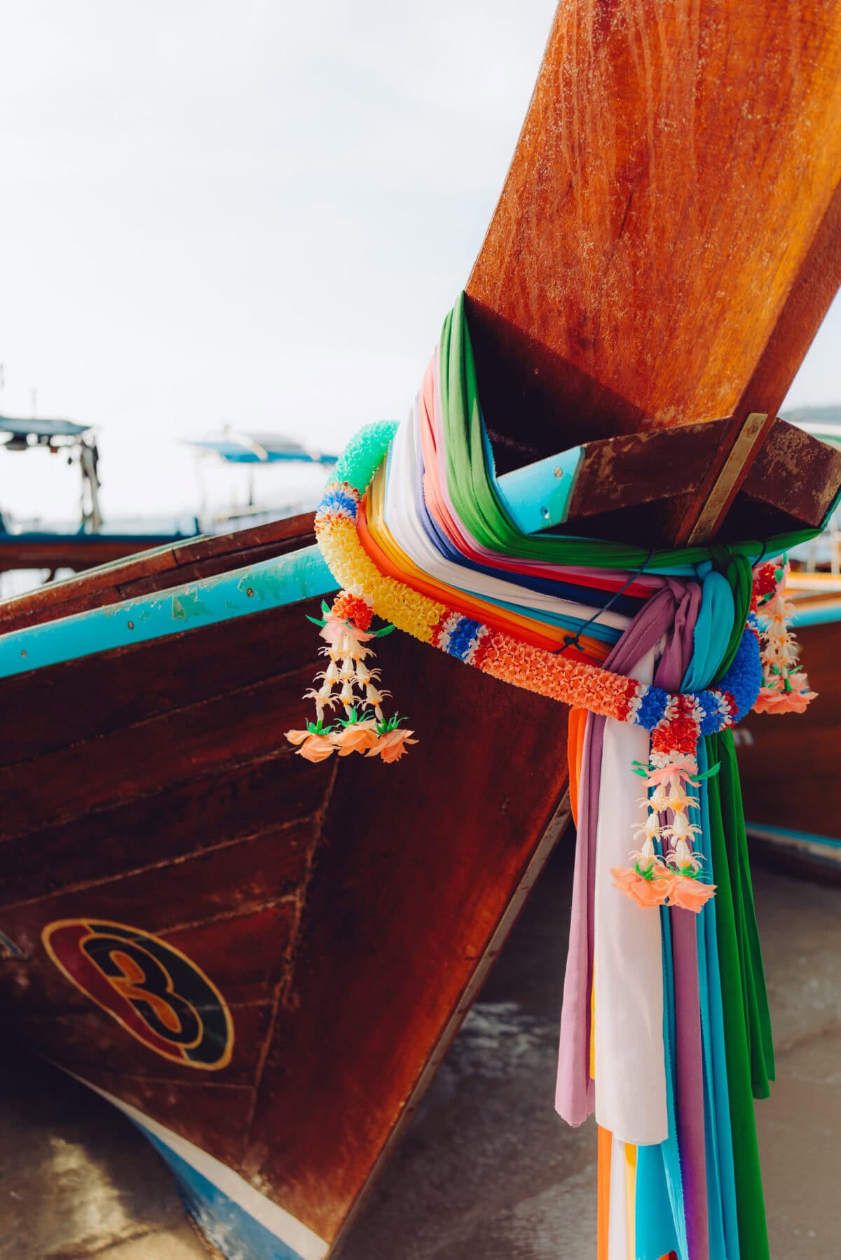 Decorated bow of a traditional wooden boat on the beach
