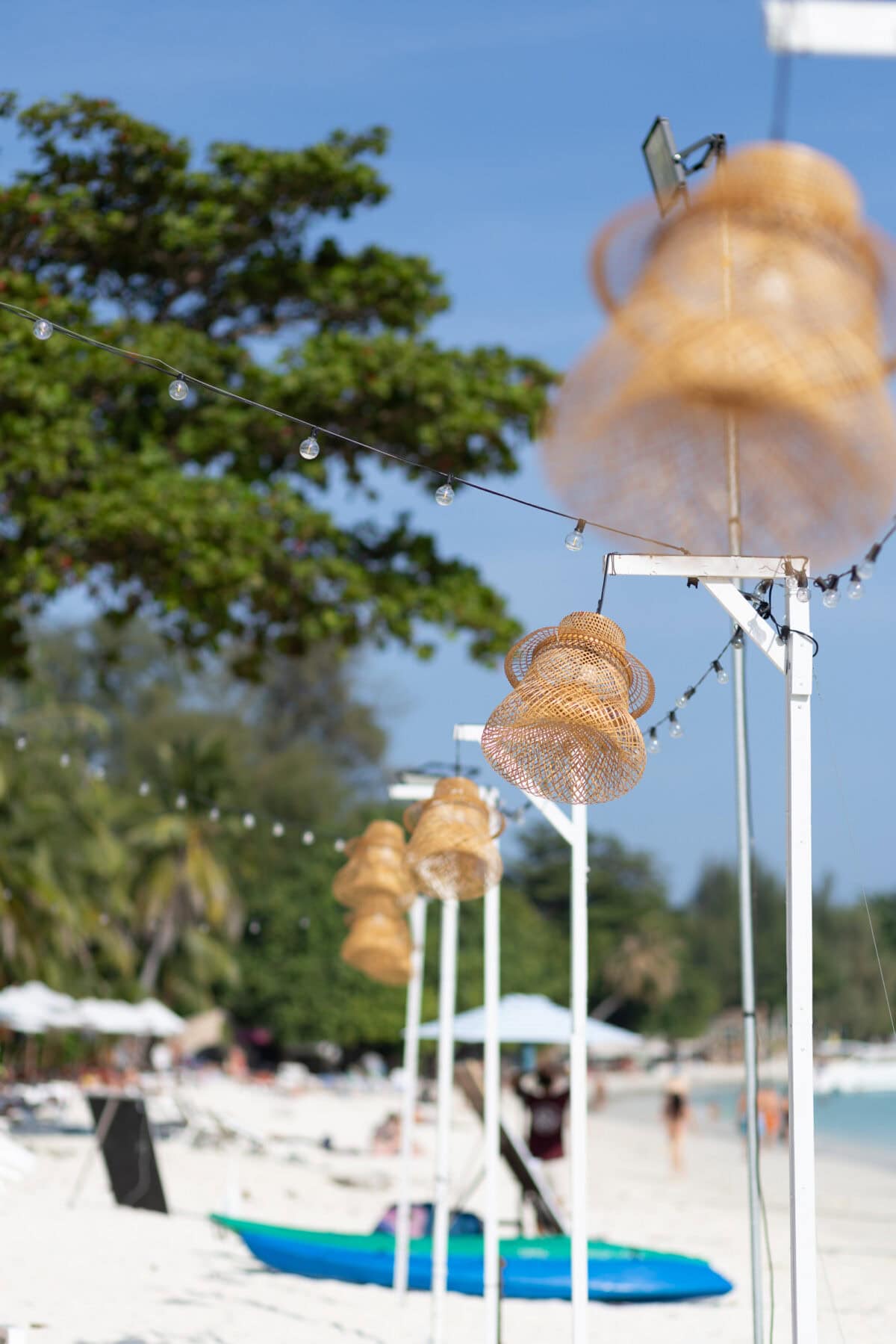Rattan lamps on the beach with fairy lights