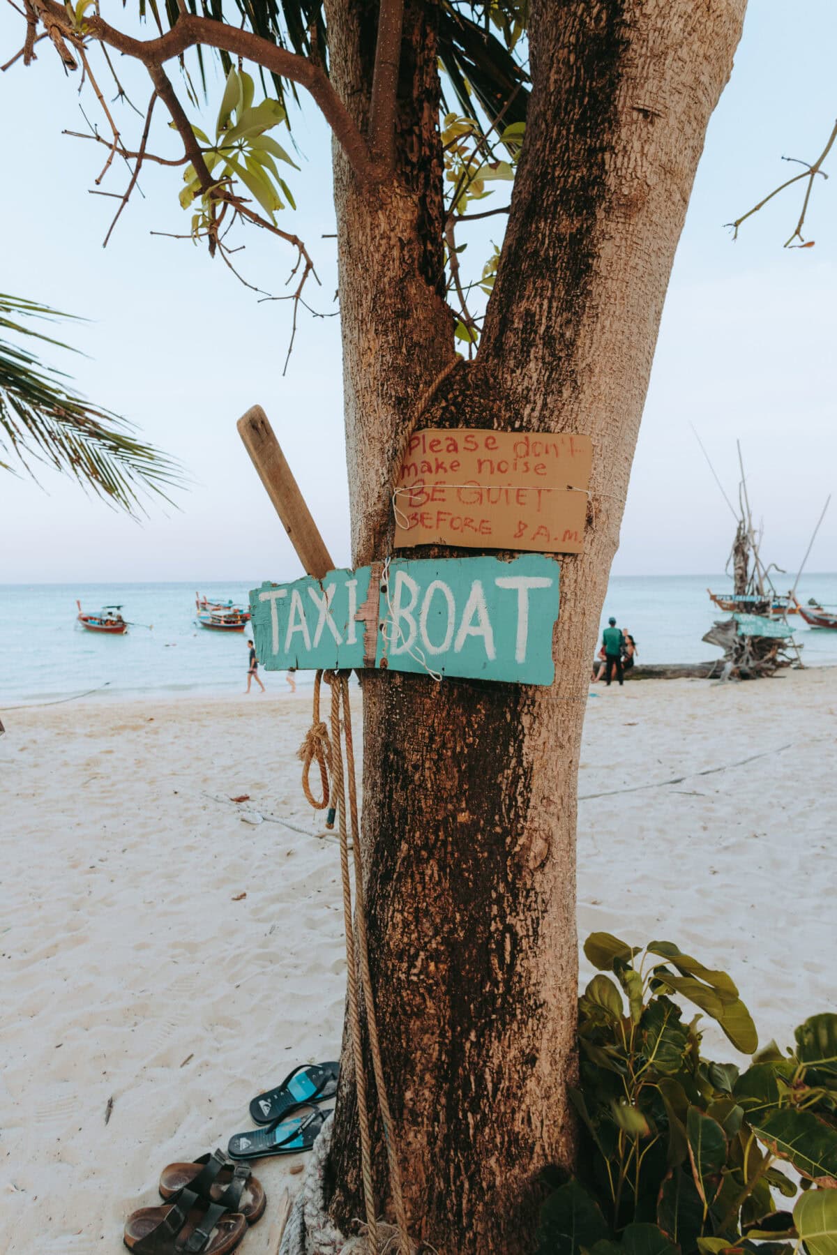 Wooden sign Taxi Boat on a tree on the beach