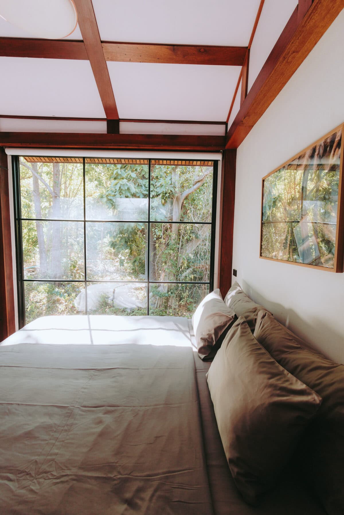 Cozy bedroom with large window and garden view