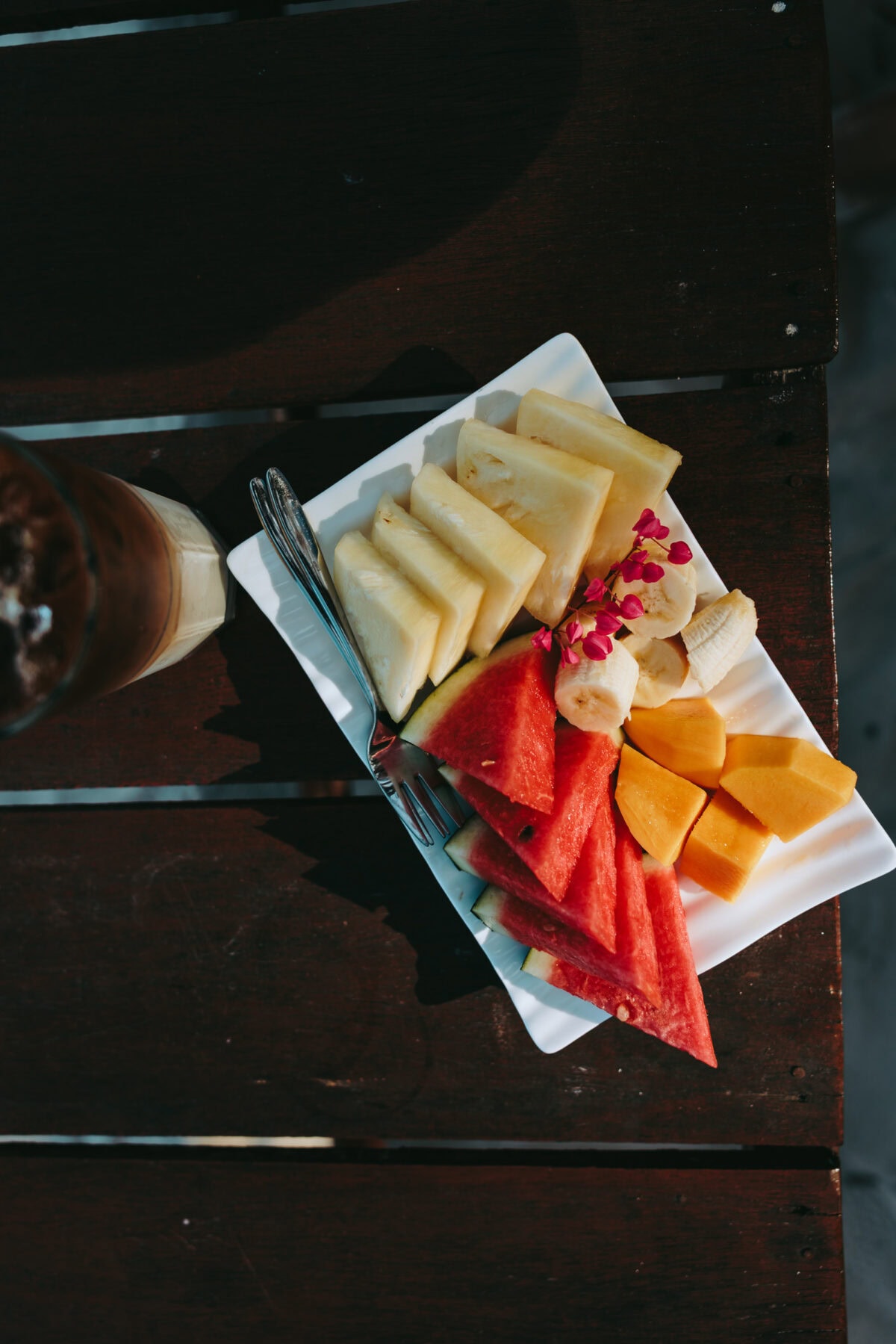 Plate with fresh fruit on wooden table