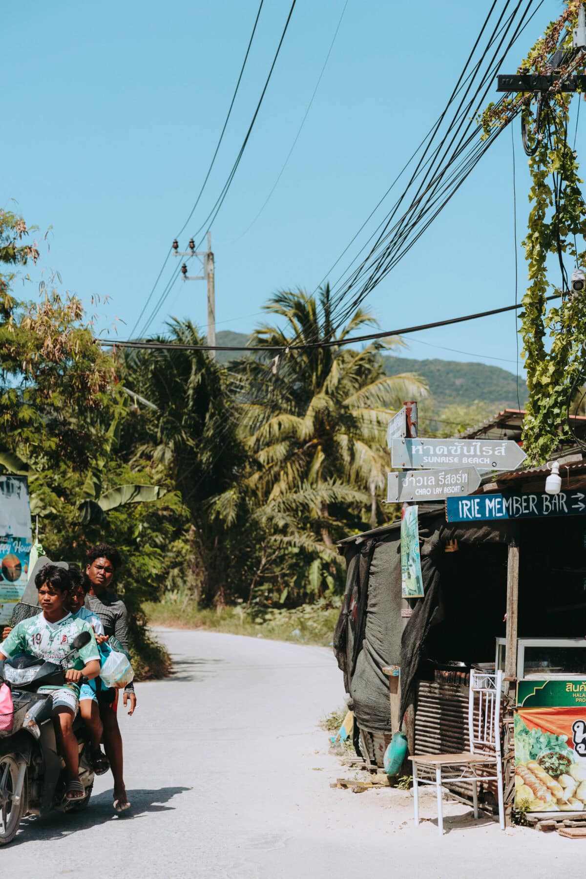Boys on scooter in tropical street