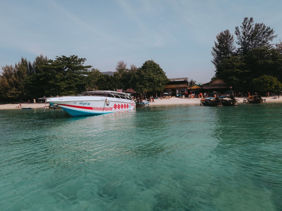 Speedboat in front of a tropical beach with turquoise water