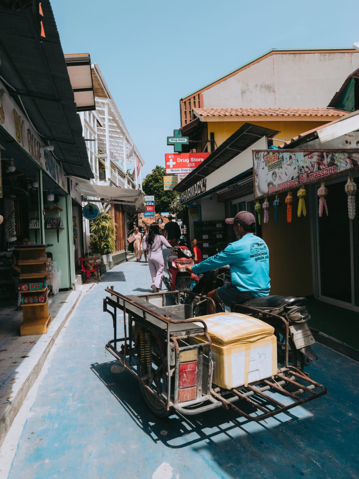 Narrow alley with scooters and small stores