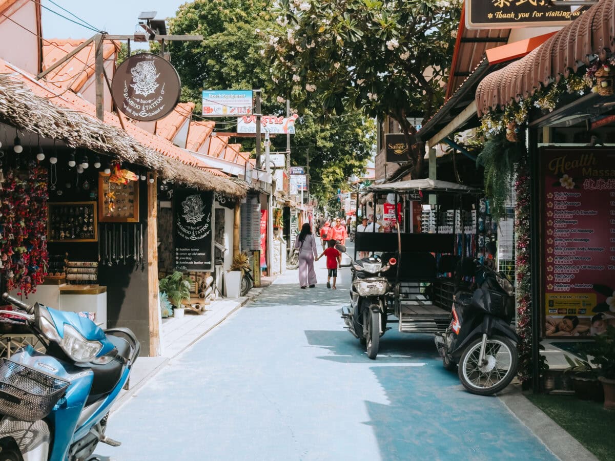 Lively alley with small stores and scooters